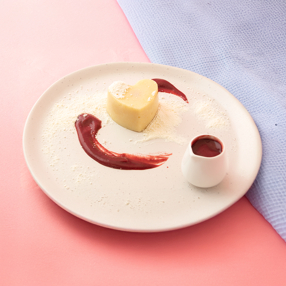 Shape It Vanilla Heart Cakes filled with pureed raspberry and topped with strawberry coulis and a light dusting of meringue dust.